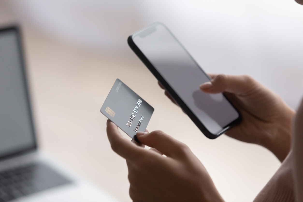 Traveler reviewing a credit card and phone for a limited-time transfer partner offer.