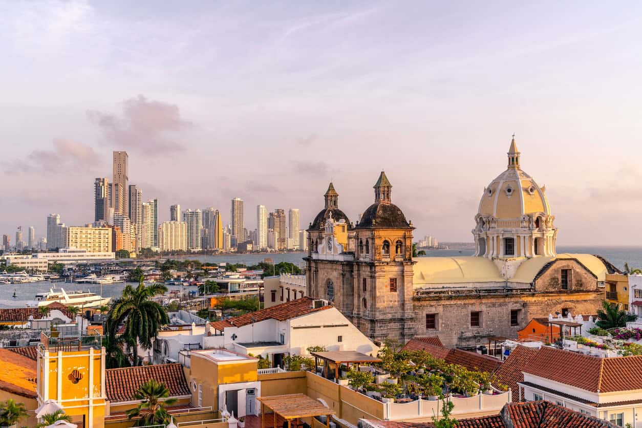Cartagena, Colombia, skyline and historic cityscape with colonial architecture, a waterfront, and modern high-rise buildings.